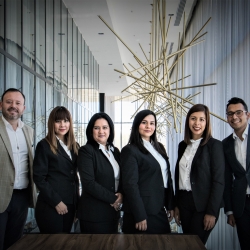 Group of men and women wearing suits.