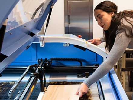 Student using laser cutter